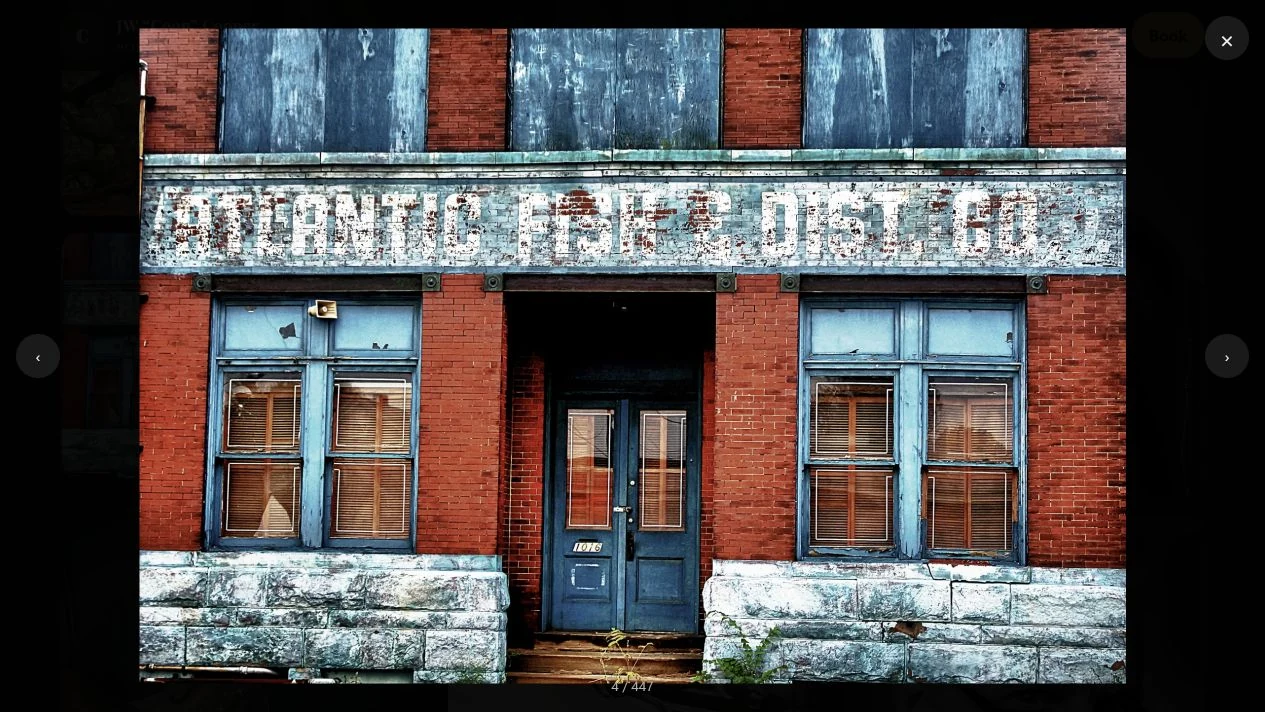 JW Cooper Photography: Red brick storefront with faded lettering, blue doors and weathered windows